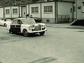 Old Car infront of a building 