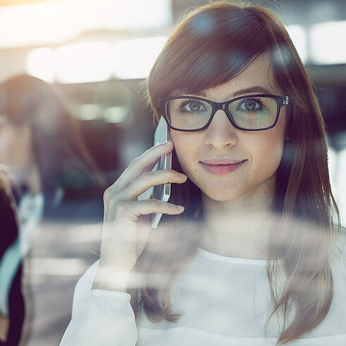 Woman smiling while talking on phone