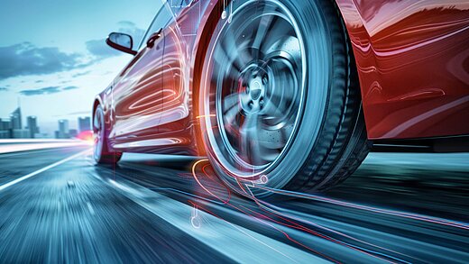Close-up of a red sports car driving swiftly along the road