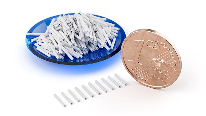 Tubes made of structural ceramics next to cent coin