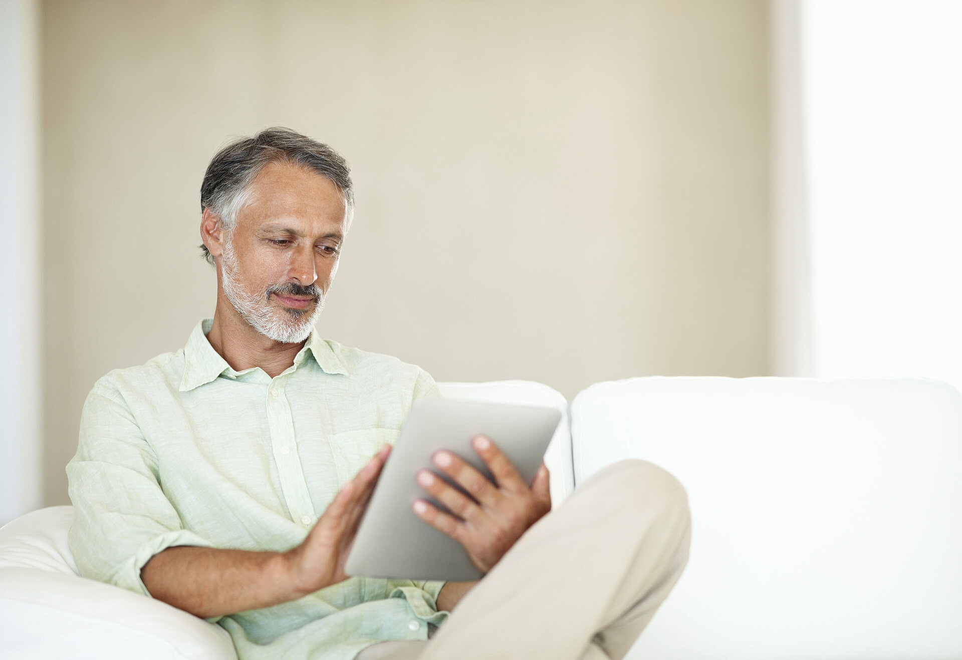 Man sits with a tablet in his hand
